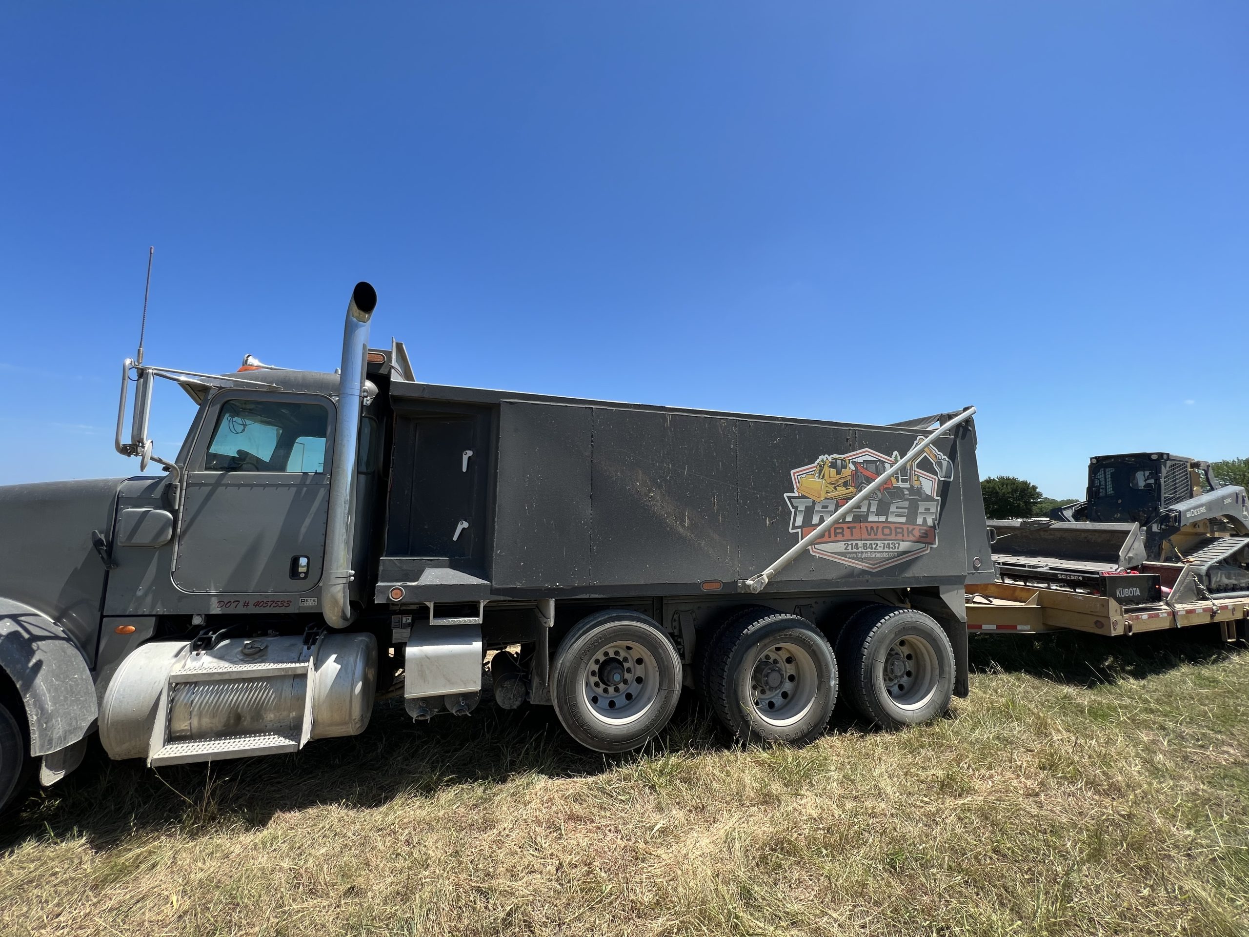 Triple R Dirt Works truck and equipment on a dirt work job site in the Texoma region